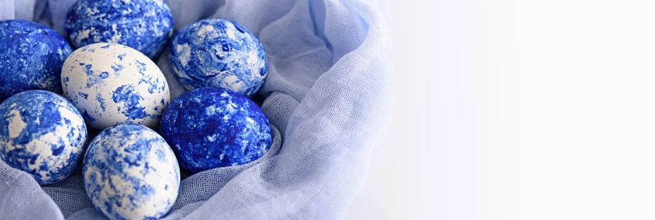 White Easter eggs with classic blue pattern and gradient effect in fabric tow Stock Photos