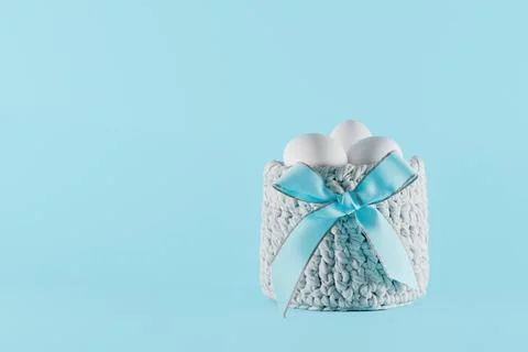 White Easter eggs in a gray basket Stock Photos