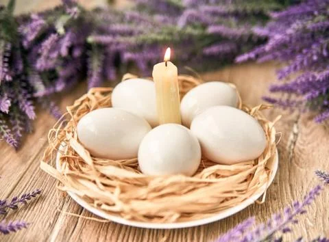 White Easter eggs with lighting candle. Happy Easter Concept. Congratulations Stock-Fotos