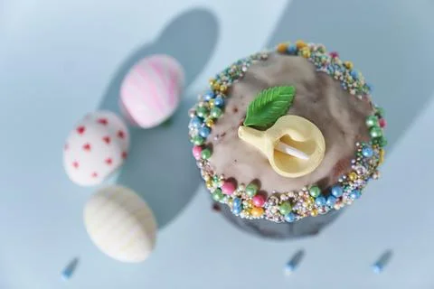 White Easter eggs with a pattern in the form of hearts and lines and a cake with Stock Photos