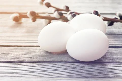 White easter eggs with willow branches on wood background Stock Photos