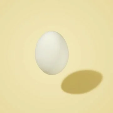 White egg in the air with a shadow, on a colored background. Morning mood. Stock Photos