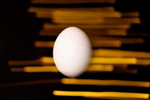 White egg on black background. Stock Photos