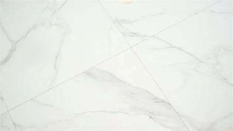 White Egg falls and Breaks on the Marble Floor in Slow Motion Stock Footage 129261103
