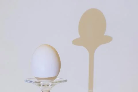 White egg on glass pedestal Stock Photos