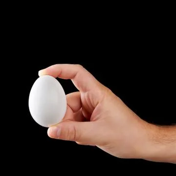 White egg in hand Stock Photos