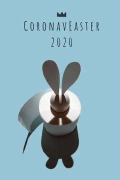 White egg with hare ears in a roll of toilet paper. Hard shadow on a light ba Fotos Stock
