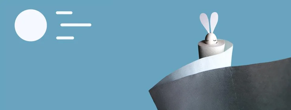 White egg with hare ears in a roll of toilet paper. Hard shadow on a light Stock Photos
