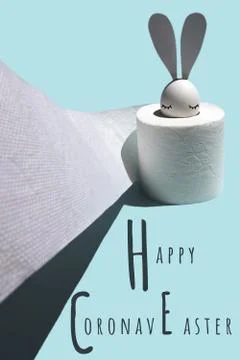 White egg with hare ears in a roll of toilet paper. Hard shadow on a light Stock Photos