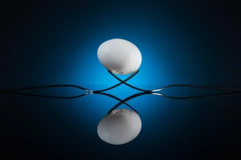 White egg lying on fork Stock Photos