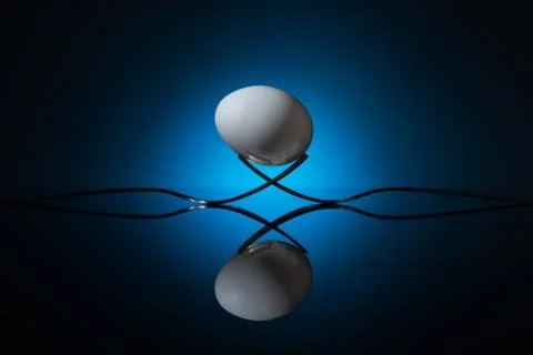 White egg lying on fork Stock Photos