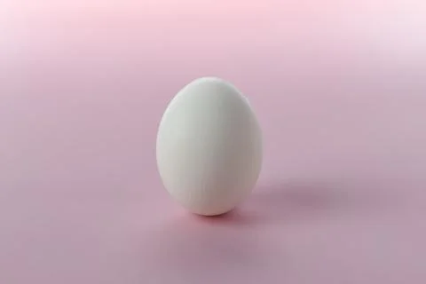 White egg on a pink background.Postcard with space for text Stock Photos