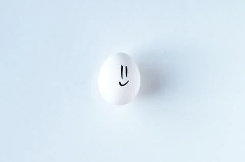 White egg with smiley on white background 写真素材