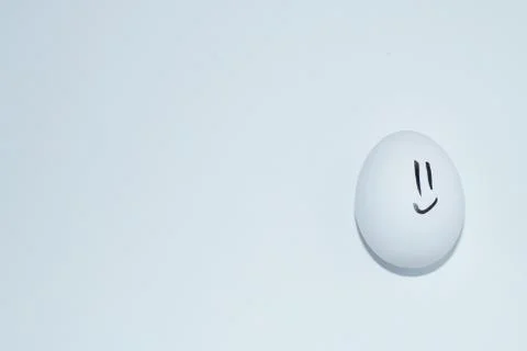White egg with smiley on white background 写真素材