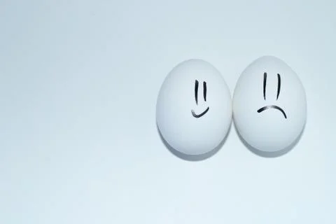 White egg with smiley on white background 写真素材
