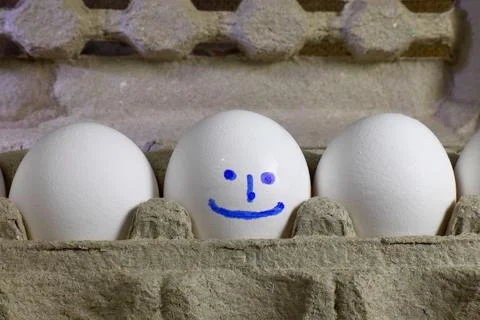 White egg with a smiling smiley face Stock Photos