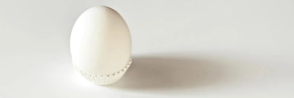 White egg on a white isolated background with shadow. Ingredient.Healthy food Stock Photos