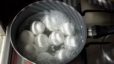 White eggs are boiled in boiling water in a pot on a gas stove. Close up. The 스톡 동영상 103153049