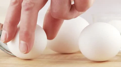 White eggs being picked up with a spoon Stock Footage 24635829