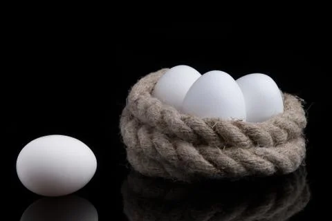 White eggs on a black background Stock Photos