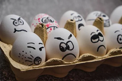 White eggs with drawn funny faces wearing medical masks at Easter holiday Stock Photos