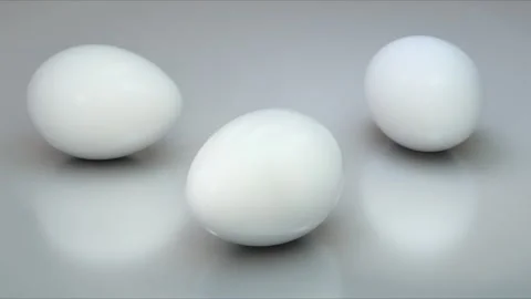 White Eggs On Grey Rotating Loop Stock Footage 302631049