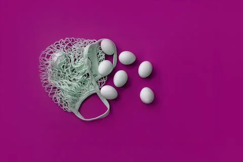 White eggs in a grid on a pink background Stock Photos