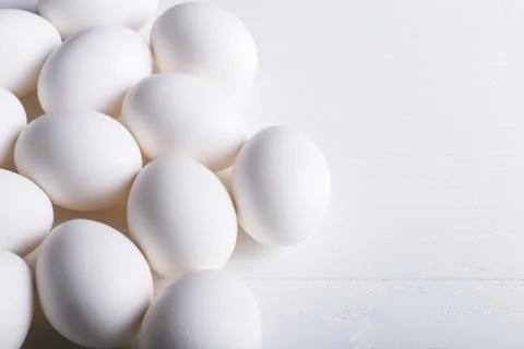 White eggs pattern, on a wooden table. Stock Photos