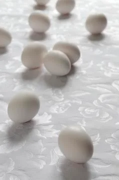White eggs on patterned fabric Stock Photos