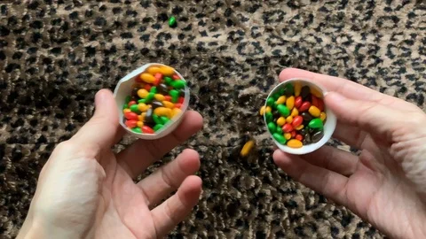 From white eggs poured colorful candy on a leopard Stock Footage 102905945
