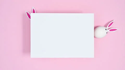 White eggs with rabbit ears appear under paper card copy space. Stop motion Stock Footage 171446961