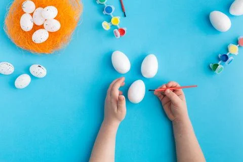 White eggs ready to be painted easter concept baby hands Stock Photos