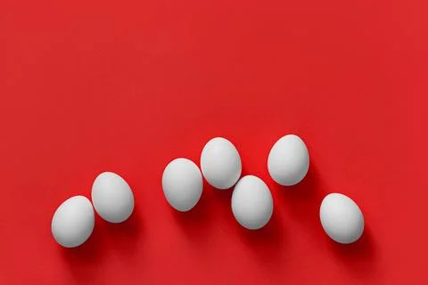 White eggs on a red background Stock Photos