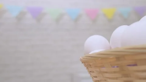 White eggs rotate in basket on blurred background of easter decoration Stock Footage 170684090