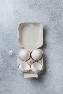 White eggs in a small paper container box top view Stock Photos