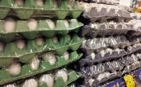 White eggs in trays packed with plastic for sale Stock Photos