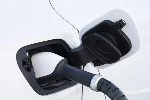 A white electric car charging Stock Photos