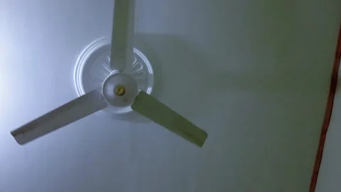 White electric ceiling fan rotating very slowly. Stock Footage 315544800