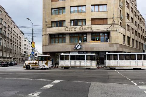 White electric excursion train driving on the road in Bratislava, Slovakia Stock Photos