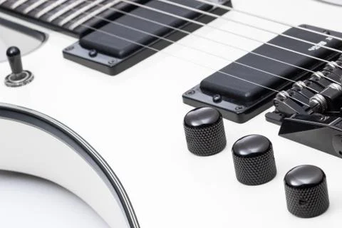 White electric guitar close up of knobs and pickups. Stock Photos