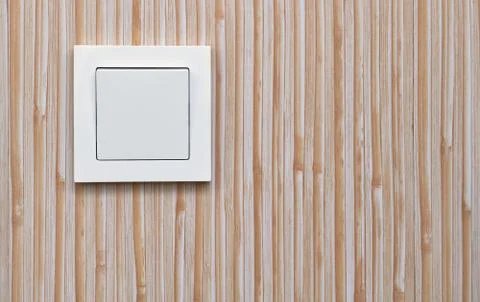White electric light switch on the background of plastic wall pa Stock Photos