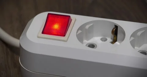 White electric portable socket with red power and on indicator, zoom-out video Stock Footage 317852020