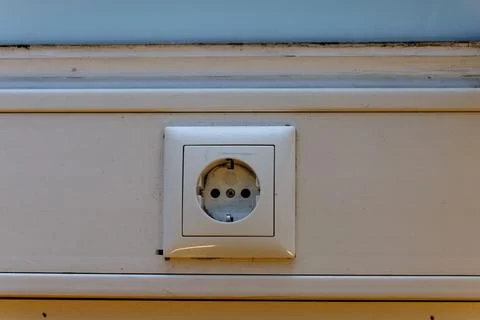 White electric power socket on clean wall Stock Photos