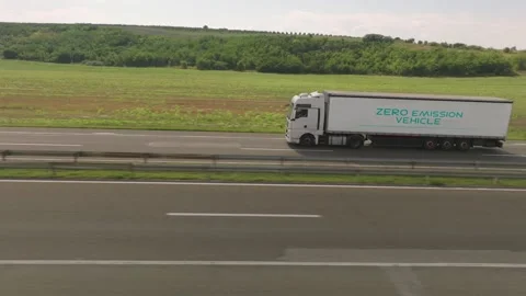 White electric semi truck with zero emission vehicle text driving on highwa.. Stock Footage 337475723