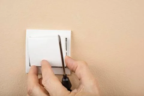 White electric switch with on a wall and without cover Stock Photos