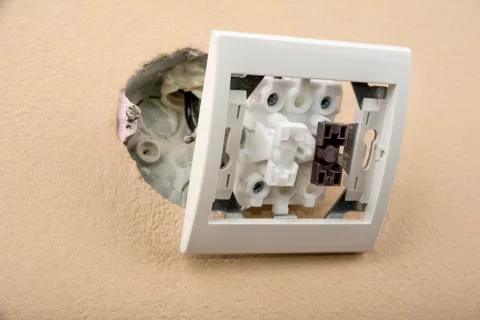 White electric switch with on a wall and without cover Stock Photos