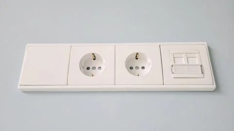 A white electrical box with two outlets and a switch Stock Photos