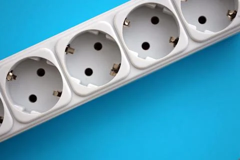 White electrical multi plug extender with european socket on bright blue Stock Photos