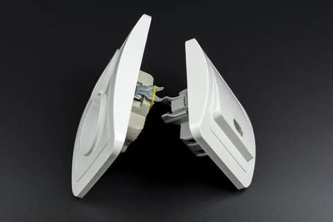 White electrical outlet and switch on black background Stock Photos