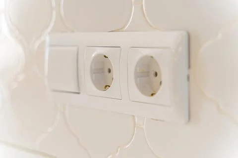 A white electrical outlet with three outlets on it Stock Photos